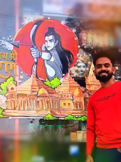 Another photo of me with the Ram Mandir artwork. The piece combines the image of Lord Ram with the temple, creating a complete devotional scene.