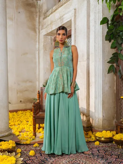 A mint green peplum top and skirt set from the Jashn-de-Fleurs collection, offering a fresh and modern festive look.