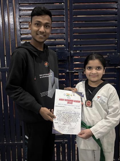 Another one of our dedicated students receiving her certificate. Each promotion is a celebration of personal growth and commitment to the art of Taekwondo.