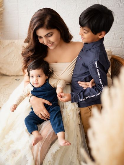 A mother's loving embrace for both her sons, big and small.