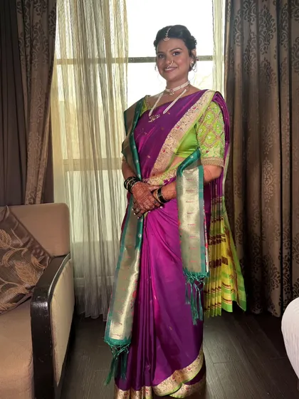 A full-length portrait of the bride in her magnificent purple Paithani. My draping service helps bring her entire bridal vision to life with effortless elegance.