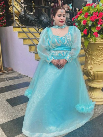 This client chose a beautiful sky-blue gown with dramatic puffy organza sleeves for a wedding event. It's a unique and elegant dress that adds a touch of modern royalty to your look.