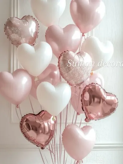 A beautiful bouquet of heart-shaped helium balloons in shades of pink, white, and rose gold. This is a simple but elegant way to decorate for a romantic occasion.