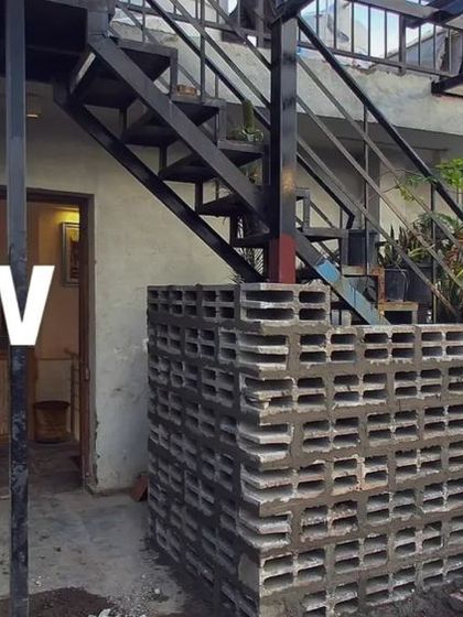 A close-up of the raw materials. The concrete jali blocks and the steel staircase are key elements of the industrial aesthetic we are building for this new cafe.