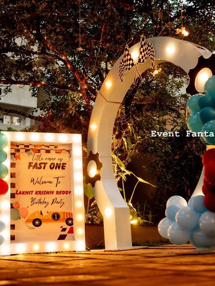 The racing-themed entrance arch lit up at night, creating an exciting and festive atmosphere for guests as they arrive.