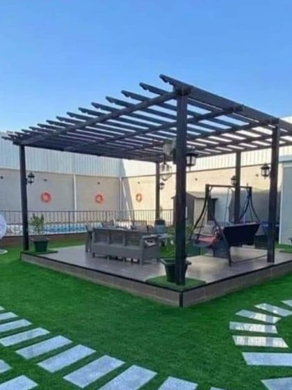 A simple yet effective pergola design for a poolside deck. It provides essential shade for relaxing and dining by the pool, complete with a hanging swing for added comfort.