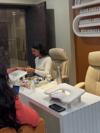 My classes are small and completely hands-on for a reason. Here's a peek at a typical session where I'm guiding a student through the application process, ensuring they get the personalized attention needed to perfect their technique.