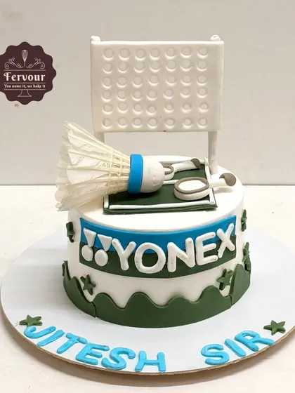 A Yonex badminton theme cake made for a coach. This design includes a fondant shuttlecock, racket, and net, making it a perfect tribute to his passion.