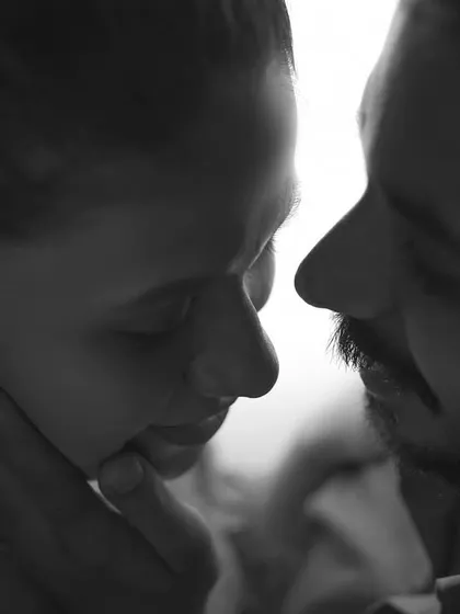 An intensely intimate black and white close-up. We focus on the gentle touch and raw emotion to create powerful pre-wedding moments that feel deeply personal and artistic.