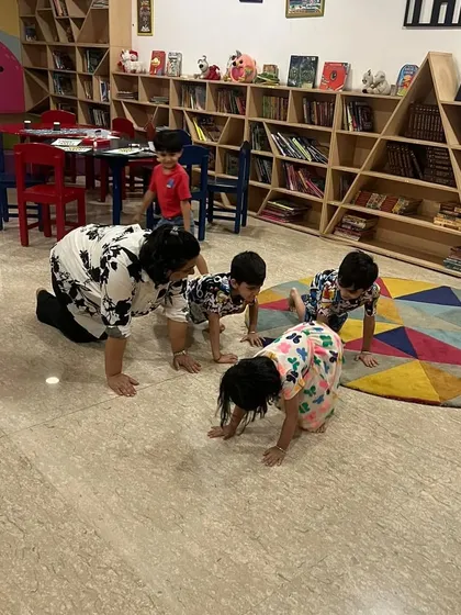 Here you can see me joining the children in a crawling game during our summer camp. I believe in participating in the activities to model enthusiasm and encourage everyone to join in.