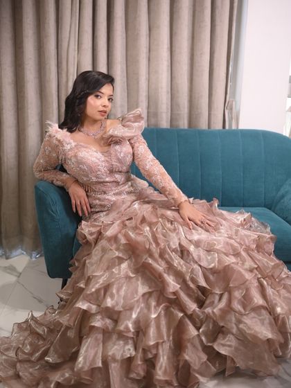 A full view of this incredible ruffled gown. The voluminous skirt and detailed bodice create a high-fashion look for any major event.