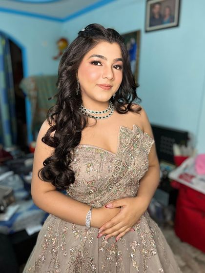 Another shot of our happy client, showcasing her beautiful makeup and the elegant gown she rented from us.