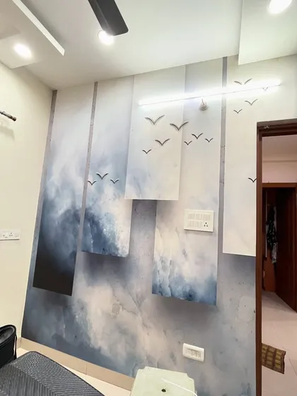 A finished installation of an abstract wallpaper featuring birds flying over a cloudy sky. The design is modern, artistic, and creates a sense of freedom.