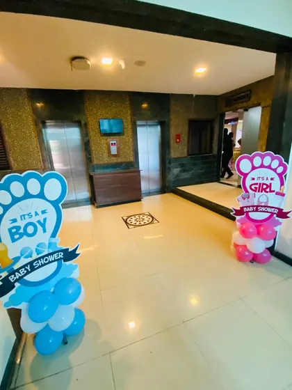 Simple and clear signage for a gender reveal baby shower, with 'It's a Boy' and 'It's a Girl' cutouts placed at the entrance.