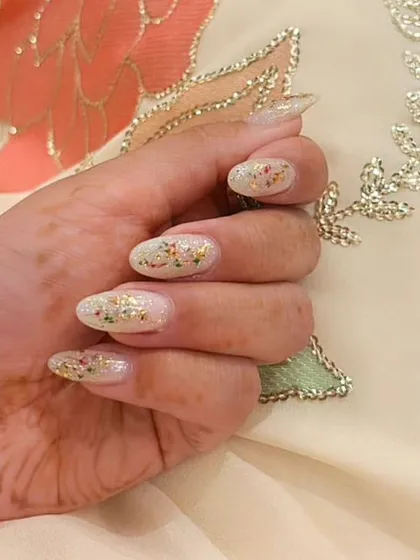 Another example of the dried-flower confetti nails, showing the beautiful, subtle colors against a shimmery base.