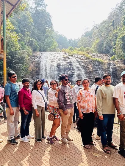 The whole group lined up for a photo at the magnificent Abbey Falls. The powerful cascade provides an impressive backdrop for our Coorg adventures.