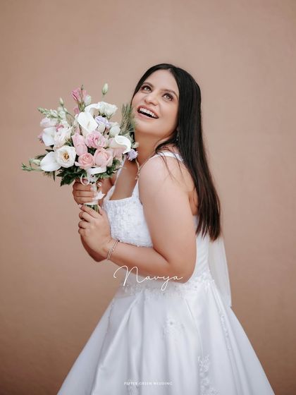A joyful portrait of the bride looking up, her happiness absolutely radiant. This candid moment captures the pure bliss of her wedding day.