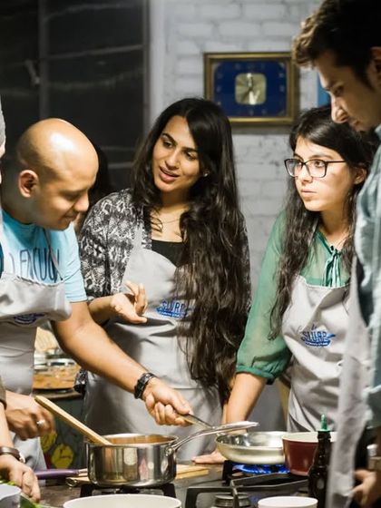 Teamwork makes the dream work. Participants huddle together to perfect their sauce, a great example of the collaboration we see in every corporate workshop.
