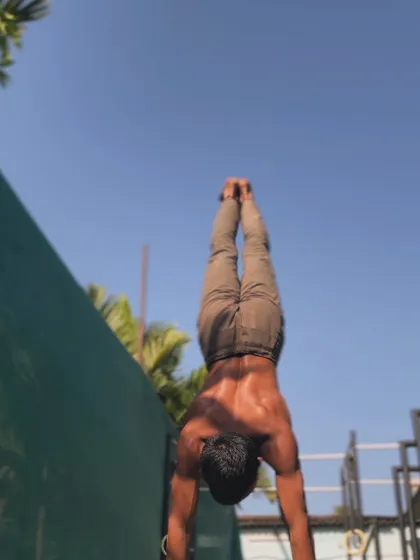 A handstand against the wall, a key progression for building the endurance and alignment needed for a freestanding handstand.