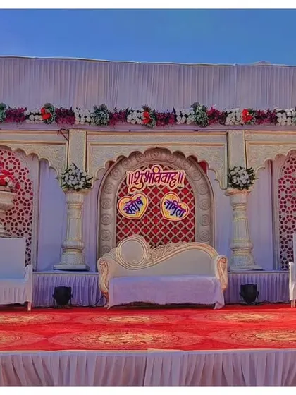 This is a Rajwada theme stage I created for an engagement. It features traditional arches, pillars, and a detailed backdrop, giving the event a royal and ethnic feel.