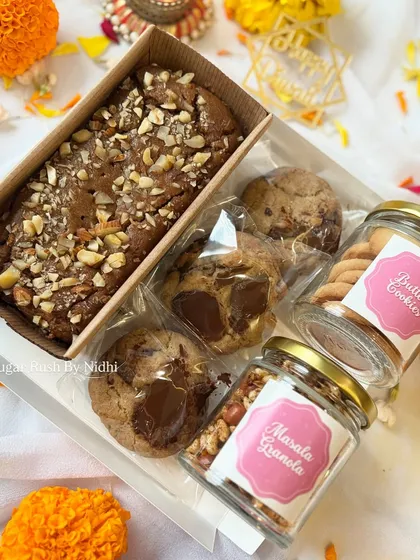 'The Joy Box' for Diwali, featuring a tea cake, three chocolate chunk cookies, and jars of butter cookies and masala granola.