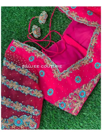 Another angle of the pink blouse with sheer sleeves, showing the included embroidered tassels that can be attached to the back closure.