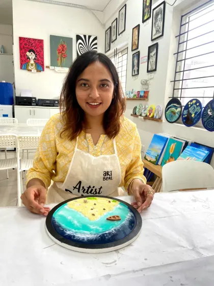 A participant proudly holds up her finished resin beach art. The sense of accomplishment is one of the best parts of the workshop.