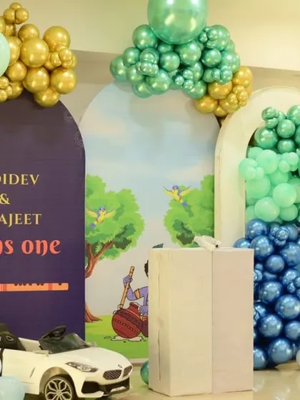 Another angle of the Krishna-themed setup, showing the arched backdrops and balloon garlands.