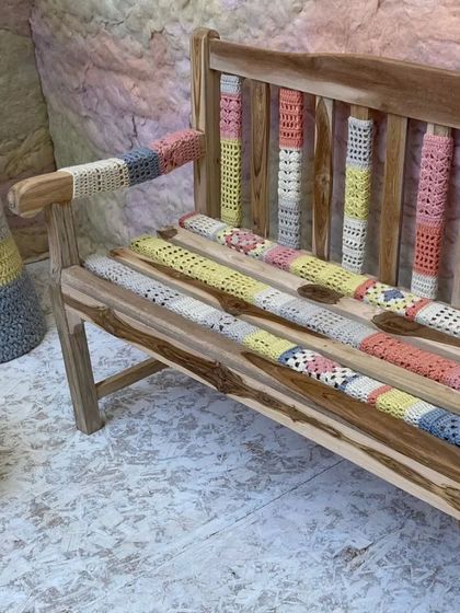 A wooden bench adorned with custom-crocheted sleeves for the 'Hope You're Well' installation. This detail highlights our focus on infusing everyday objects with warmth, craft, and a sense of care.
