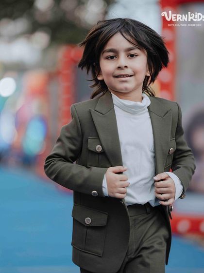 A candid moment of joy. These brothers are comfortable and stylish in their matching outfits, designed for both looks and play.