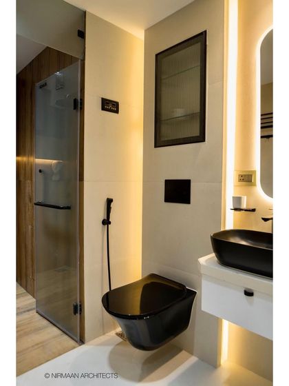 A master bathroom with back-lit mirror and a separate glass shower cabin. The warm, indirect lighting creates a relaxing ambiance, perfect for unwinding at the end of the day.