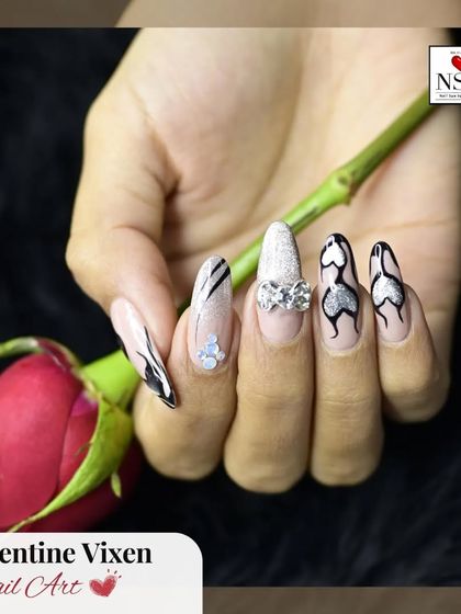 This edgy Valentine's design is for the bold at heart. It combines black abstract lines, silver glitter, and heart-shaped outlines with a sparkling rhinestone bow accent for a look that’s both romantic and fierce.