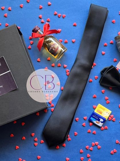 Another look at our popular Groomsmen proposal boxes. The sleek black box is filled with everything the guys need to suit up, including a tie, bow tie, and a fun "open bar" promise.