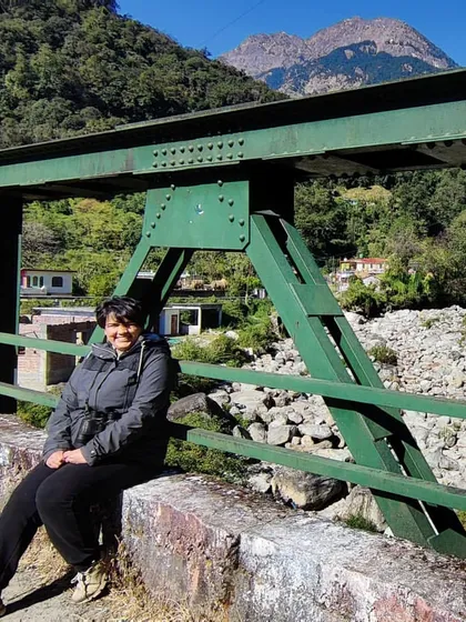 My partner taking a moment to enjoy the view from a bridge in Uttarakhand. My photography aims to capture not just the grand landscapes, but the personal experience of being in them.