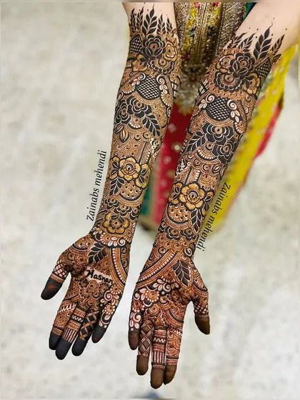 Full bridal arms featuring a beautiful mix of styles. The large flowers provide a bold statement, while the intricate netting and paisleys add depth and richness.