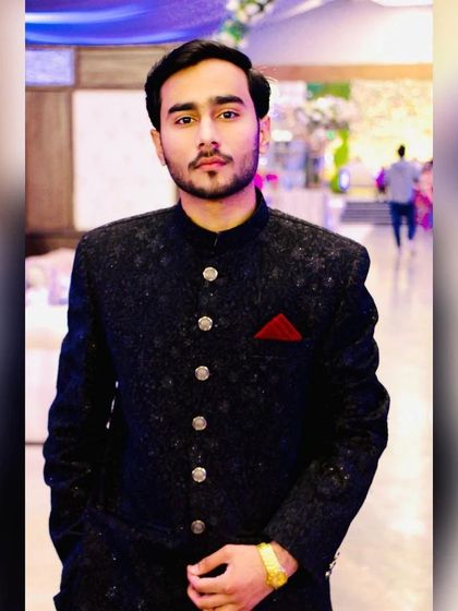 A handsome groom in a black bandhgala. This is a popular choice for receptions, offering a look that is both traditional and modern.