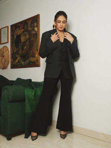 This shot captures a more posed, fashion-forward moment, with the subject adjusting her blazer.