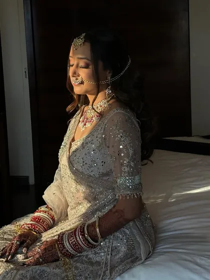 Bathed in the golden hour light, Tanvi's makeup looks absolutely flawless. The warm light enhances her dewy skin and the soft shimmer on her eyes.