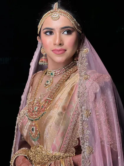 A regal portrait of the bride. Her makeup is bold and confident, perfectly matching the grandeur of her wedding attire.