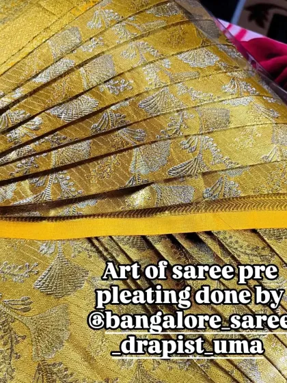 The art of saree pre-pleating, showcased on a beautiful yellow silk saree. Each pleat is perfectly defined, ready for a client.