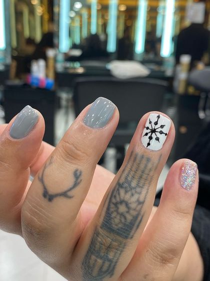 A simple yet striking design with a grey base, a silver glitter accent, and a black snowflake stamp on a white background.