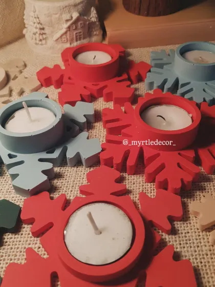 A collection of our Snowflake T-light holders in festive red and cool blue. Each one is handmade from Jesmonite and perfectly sized for a standard tea light, creating a cozy, winter-themed glow.
