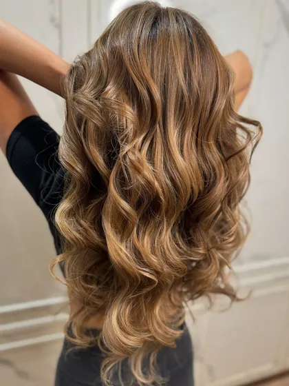 The back view of this blonde balayage, styled to perfection with soft curls.
