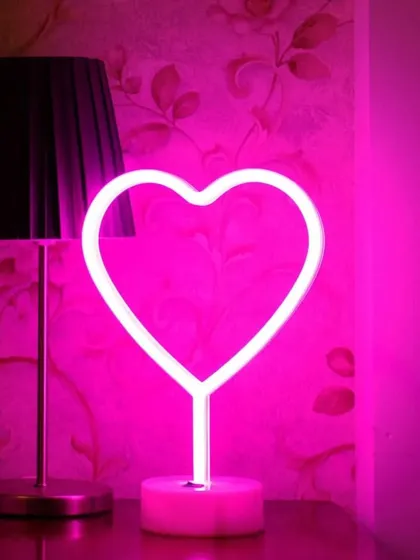 A cute heart-shaped neon lamp that can be used as a decor accent for a proposal, engagement, or first-night setup.