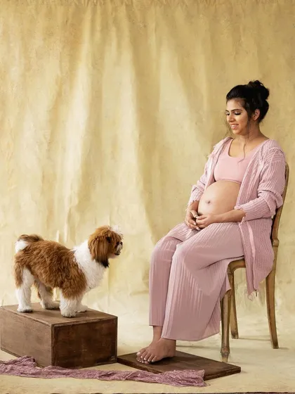 A quiet moment between a mother-to-be and her loyal companion. Pets have a wonderful way of bringing a sense of calm and love to a photoshoot.