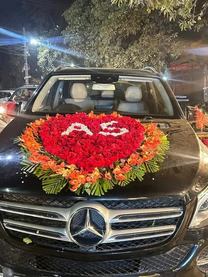 A full view of the Mercedes decorated with a red rose heart and the couple's initials. This premium decoration is done at your doorstep.