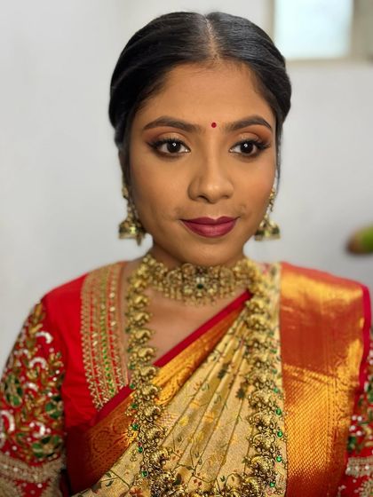 A portrait of my bride Madhu, looking absolutely stunning for her wedding. The classic eye makeup and bold berry-red lip create a look that is both traditional and striking.
