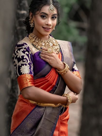 The model's confident smile and beautiful attire make for a captivating image.