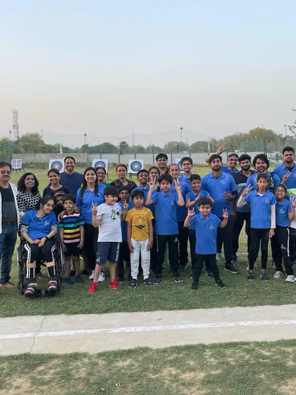 This is our family. A group photo of our diverse and inclusive community of para-archers, young athletes, coaches, and parents gathered at our outdoor archery range in Gurugram.