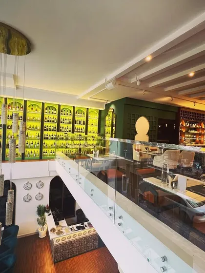 Welcome to our Mediterranean paradise. We designed the space to be modern, warm, and relaxing, featuring a stunning two-story wine display that sets the stage for an unforgettable fine dining experience.